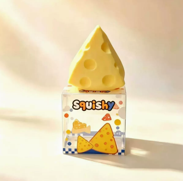 A soft and pliable cheese-shaped squeeze and release toy for relieving stress