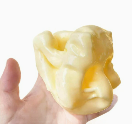 A soft and pliable cheese-shaped squeeze and release toy for relieving stress